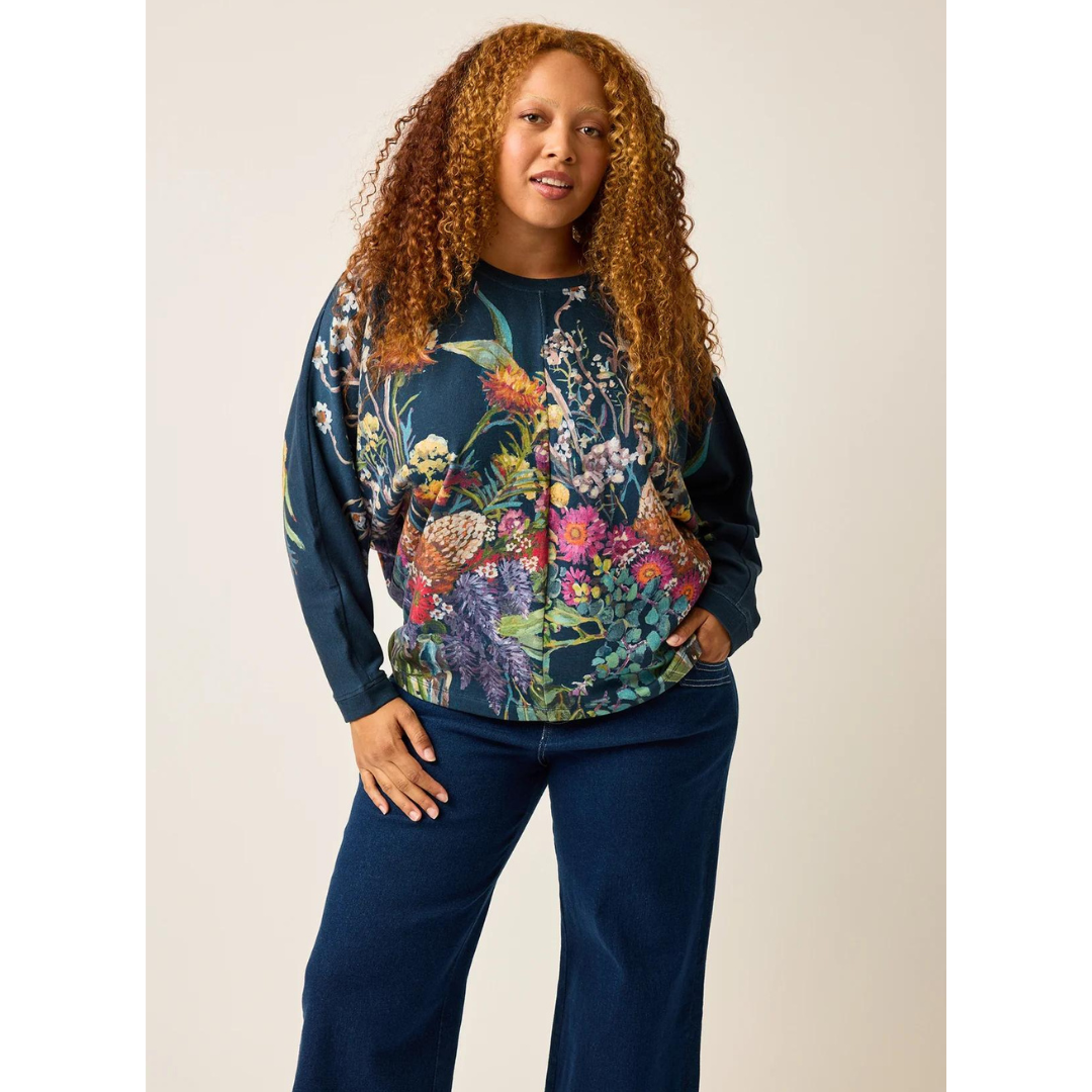 The relaxed fit of the Dahlia Batwing Sweat ensures both comfort and versatility. Crafted from premium organic cotton French terry. It not only offers a soft and cozy feel but also reflects a commitment to sustainability. It drapes elegantly on the body, and in bold artful print by Emily Wright.  Long sleeve oversized batwing sweat, crew neck and length that skims the hip. Nancybird