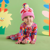 Snug as a bug! Nurture curious and creative young minds with this fluffy knit beanie for babies and kidsFeatures a folded up border, dreamy pom pom, and images from Halcyon Nights new collection on both sides.