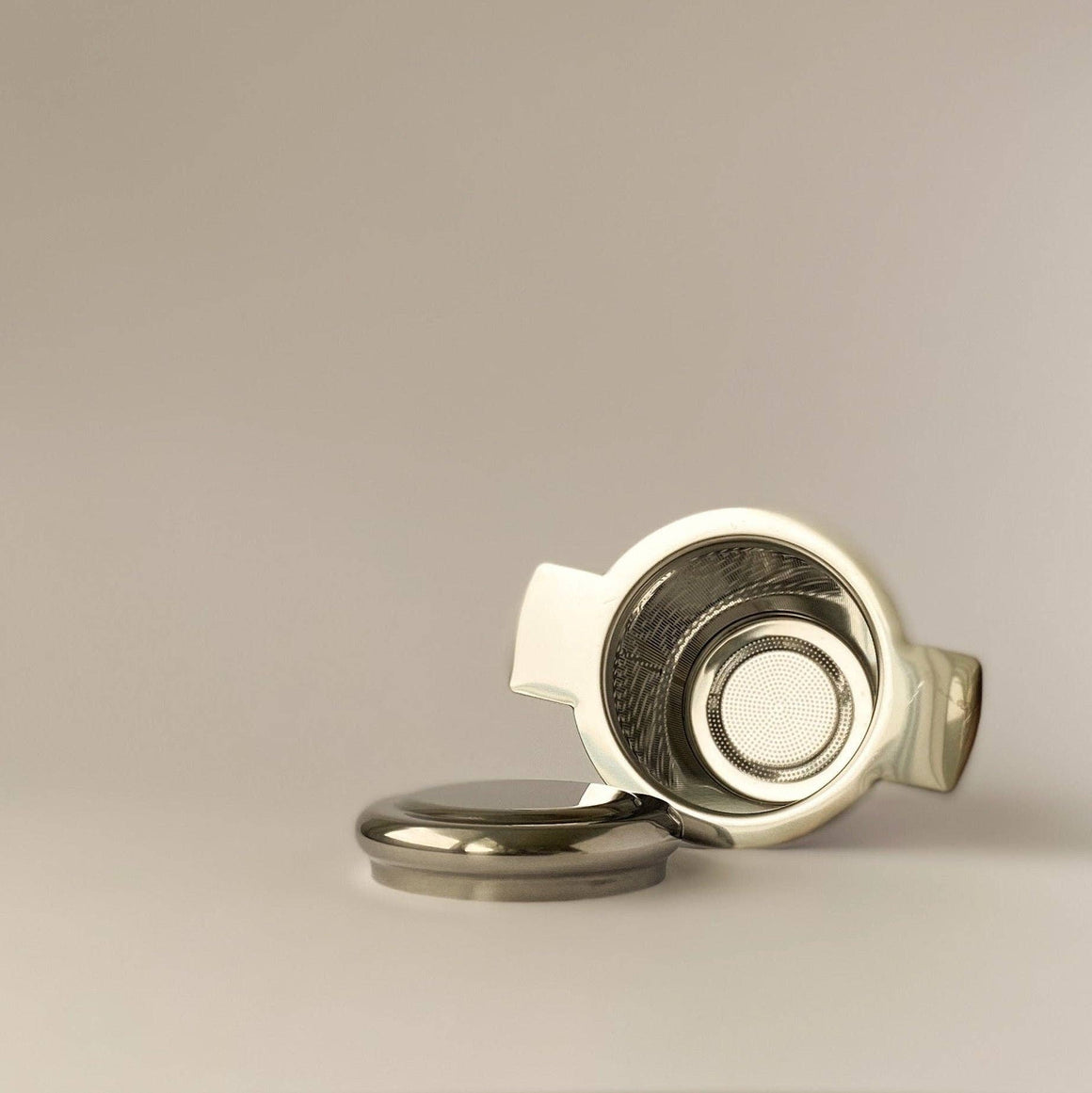 Stainless steel tea infuser with matching lid.