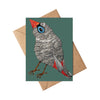 Greeting card with a colorful bird illustration on a green background, accompanied by a brown envelope.