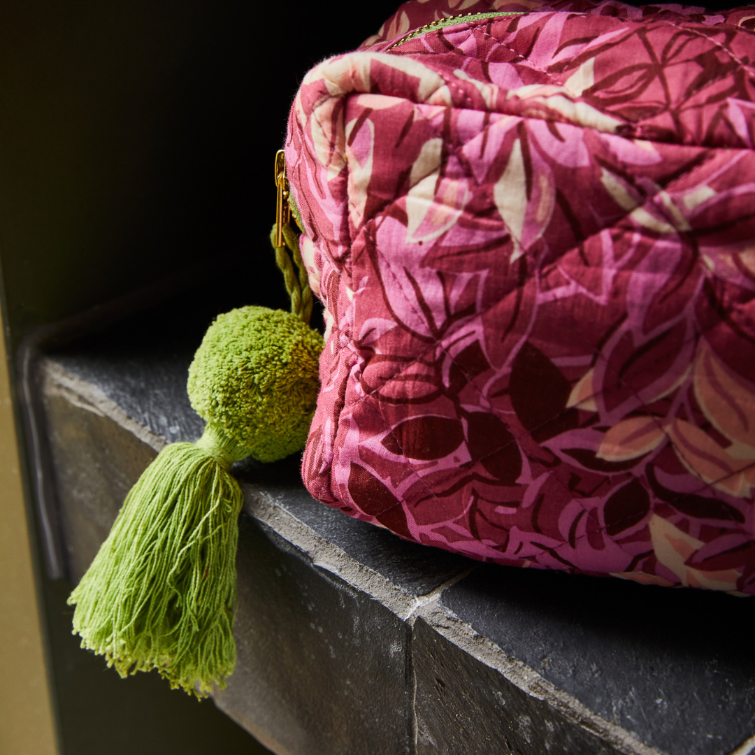 Quilted plumberry bathroom bag with lime green tassel