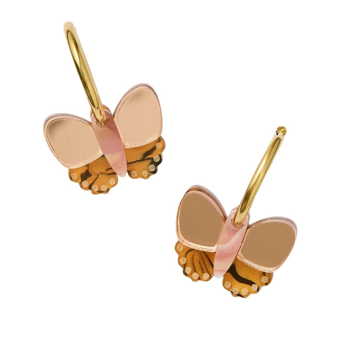 Butterfly-shaped earrings with gold and rose gold accents on a white background