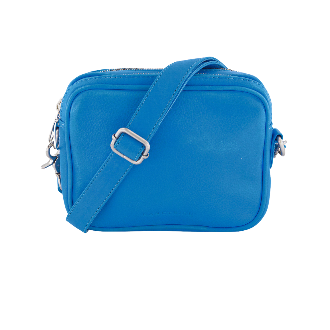 We’ve made this popular style slightly bigger to add flexibility to this every day shape and we just LOVE this fun bright blue!  Crossbody bag with vegetable tanned leather piping, strap and body. Double top zip sections for easy organisation, cotton lined. Nancybird