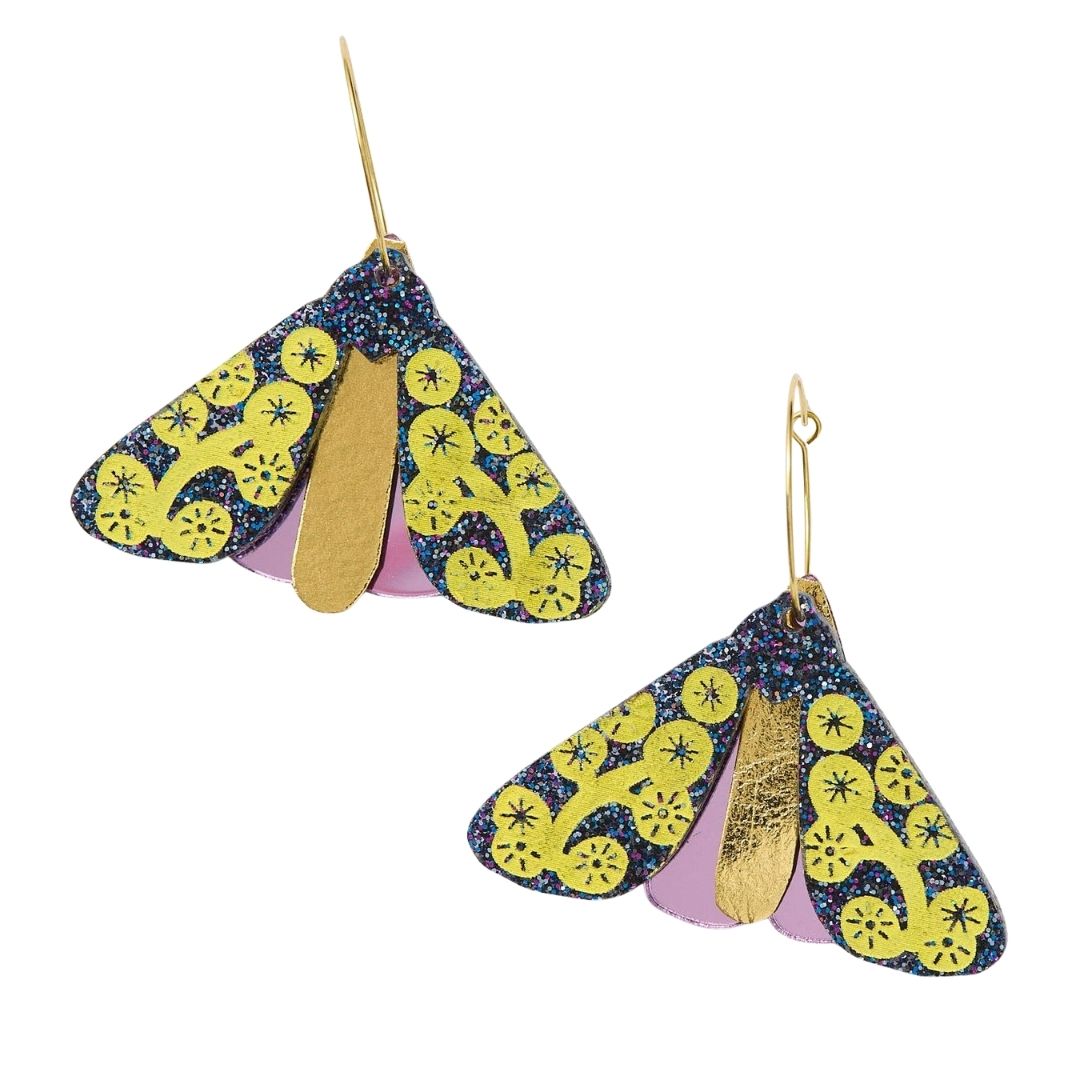 Pair of midnight sparkle moth-shaped earrings with yellow wattle patterns on it, on a white background
