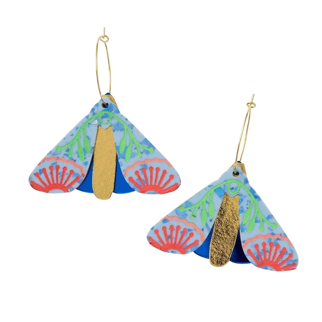 Periwinkle cobalt moth-shaped earrings on a white background