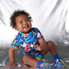 Break up the monotony of meal time with a fun and practical bib from Halcyon Nights. This print is called Rocket Ride.