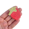 Strawberry brooch by Togetherness design. The Strawberry brooch features a hand built ceramic piece that will add a touch of colour to your outfit. Features a silver metal clasp on the reverse. As every ceramic piece has been made by hand they are each unique and