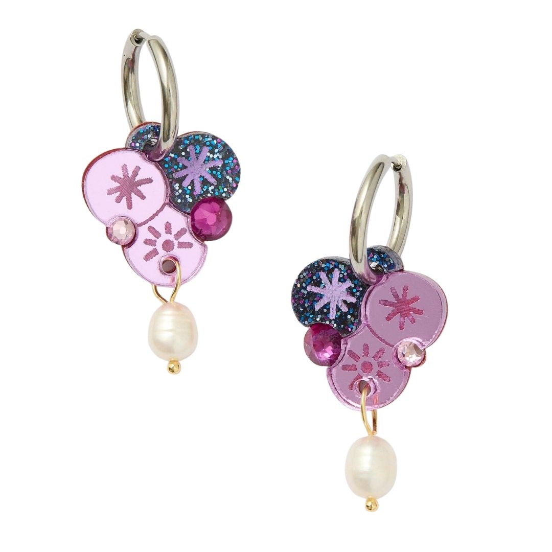 Violet earrings with wattle floral designs and pearl beads on a white background