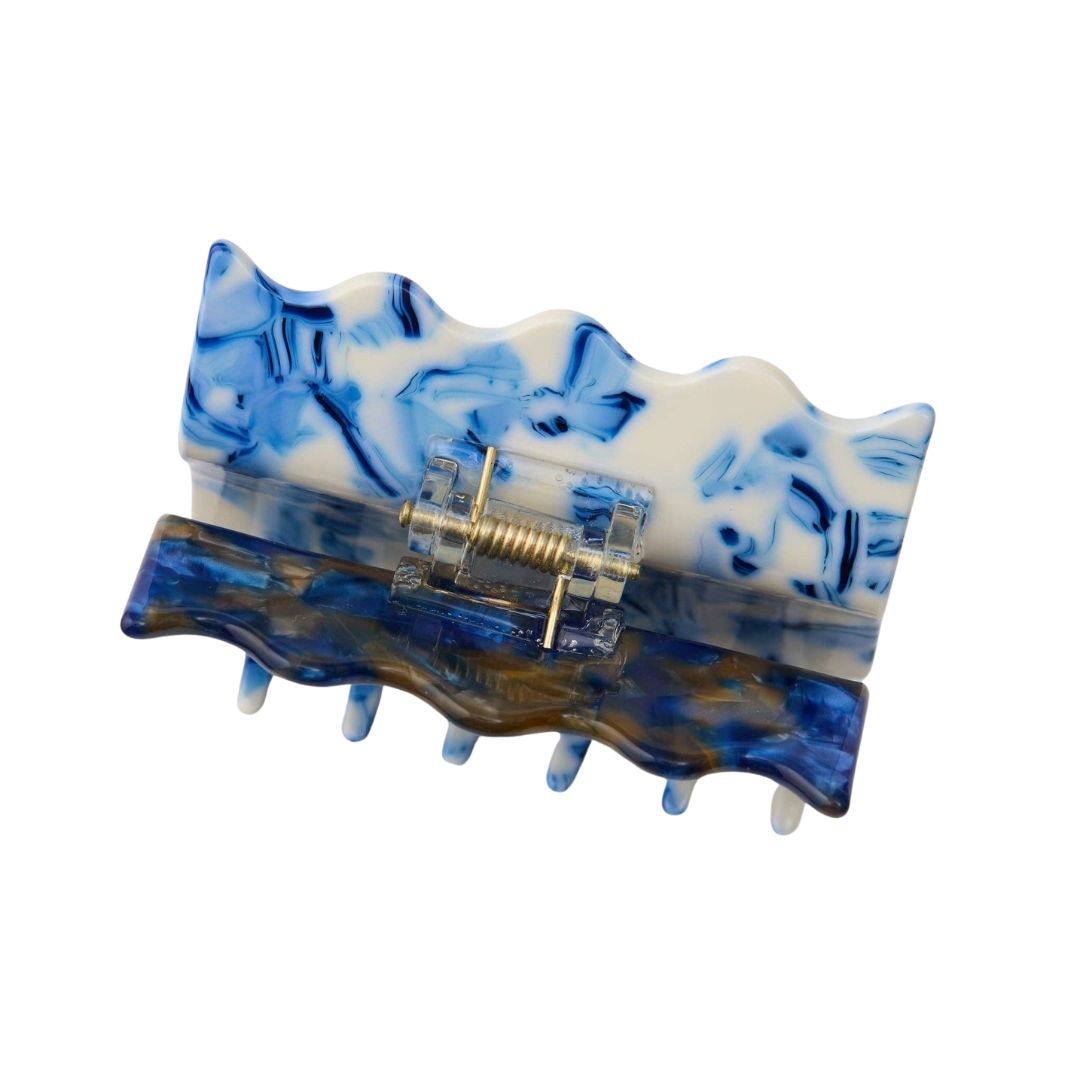 Blue and white marbled hair clip on a white background
