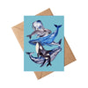Card with whale illustrations on a blue background, featuring a brown envelope.