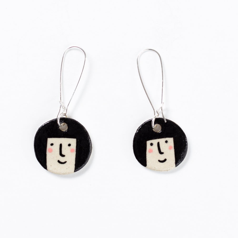 Shuh ceramic earrings -Ahh we all remember those bob hair cuts, so lets enjoy them again with these cuties!  Each piece is hand drawn and unique. Hand painted and made ceramic earrings by Shuh.  There will be a slight variation in each bead's shape and drawing.