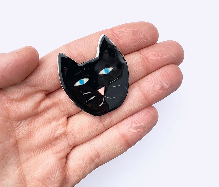 Togetherness design - The Lucky Black Cat brooch features a hand built ceramic piece that will add a friendly face to your outfit. Features a silver metal clasp on the reverse. As every ceramic piece has been made by hand they are each unique and may slightly differ from pictures in terms of shape and colour.